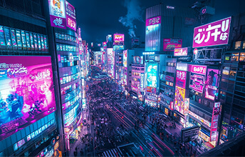 Vibrant night scene of Tokyo, Japan, with neon-lit buildings and crowded streets in the bustling cityscape.